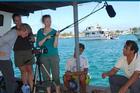 Students interview a fisherman in the Galapagos as part of the interdisciplinary course The Practice of Environmentalism: Science, Policy and Communication in the Field